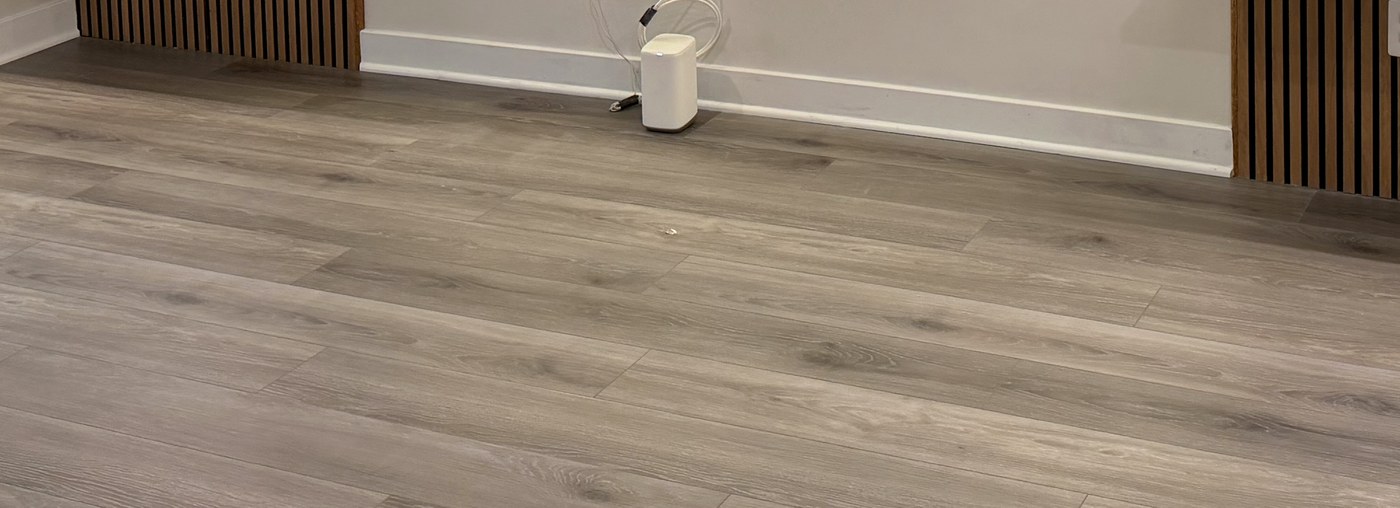 LVP wide-plank floor with cable-managed media-wall install