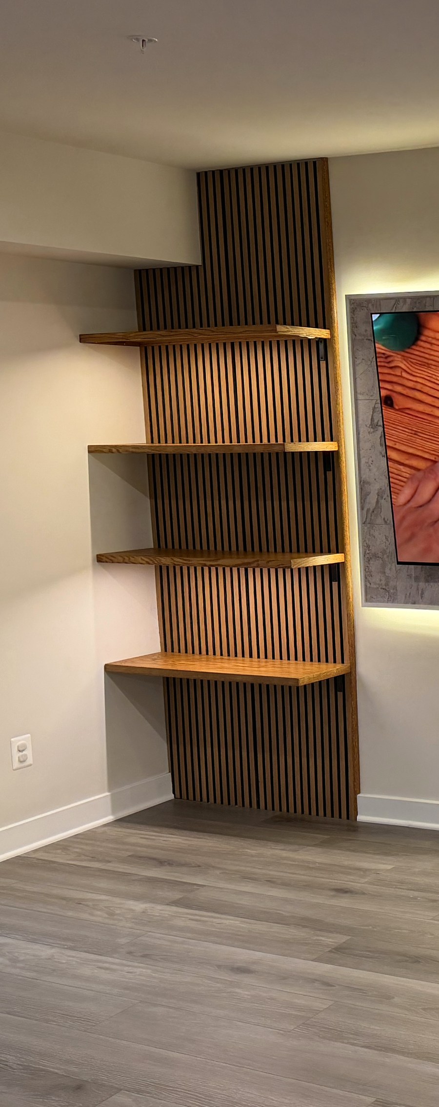 Wood-slat accent panel with floating wood shelves — detail